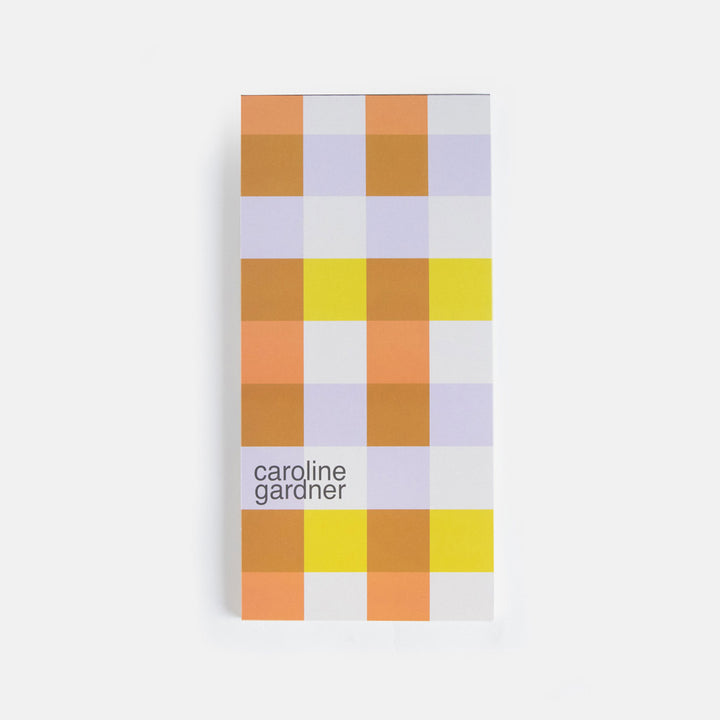 lined list pad with big flower print and a multi coloured checked print backing