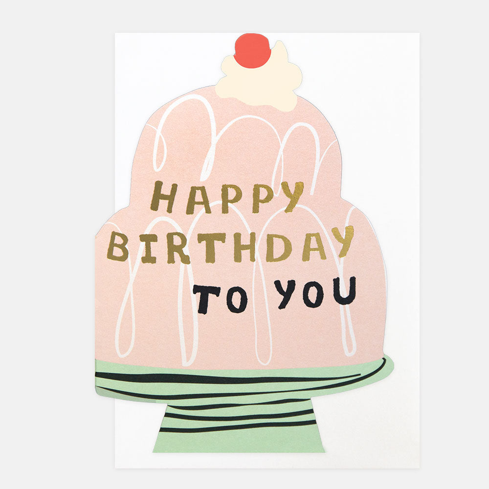 Die cut birthday cake card in the shape of a jelly on a cake stand with 'Happy Birthday to You' text on a white background