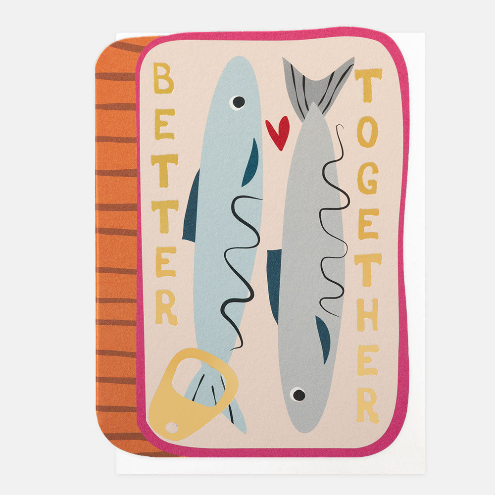 A due cut greeting card featuring a stylized illustration of a tin with two fish and the words 'BETTER TOGETHER' in yellow, plus a small red heart, shown on a white background.