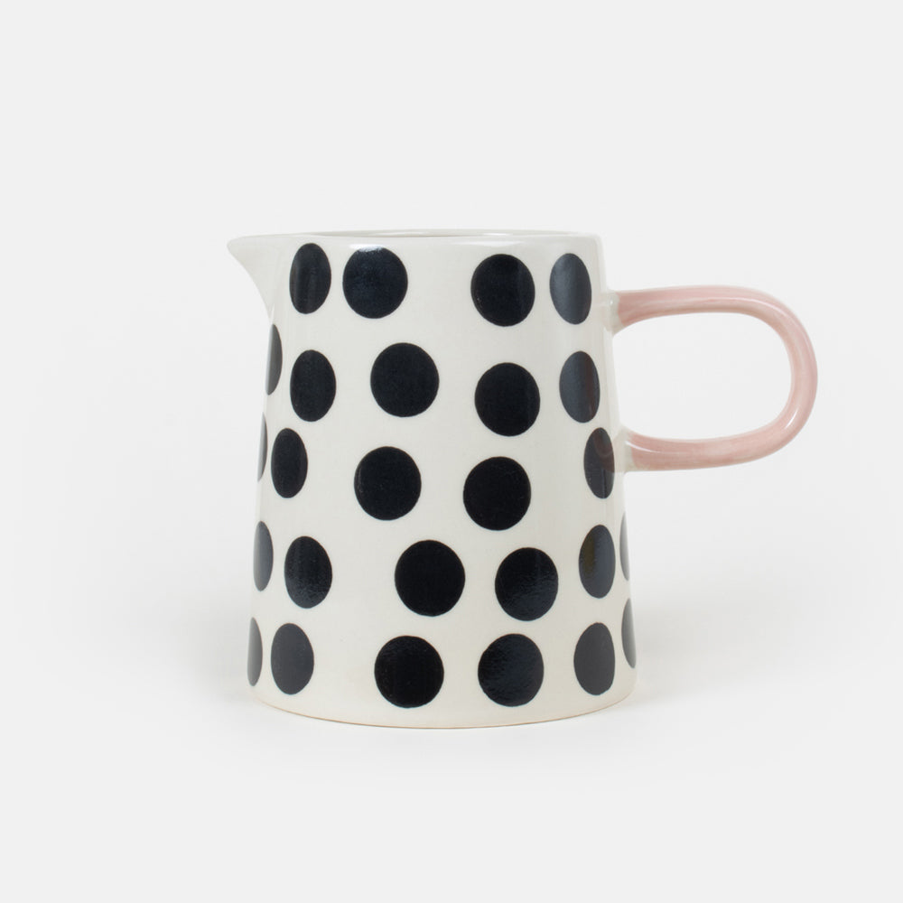 hand painted stoneware jug with black and white monochrome spot design and pale pink handle