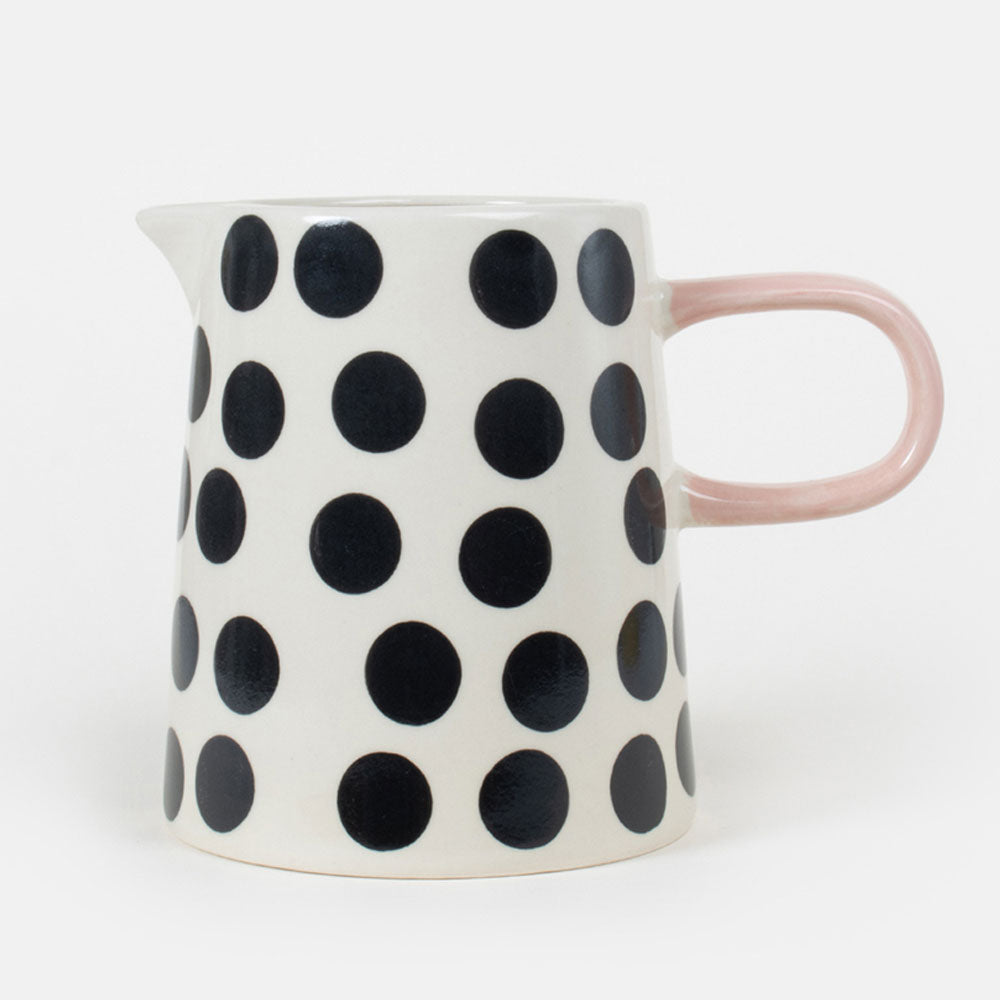 hand painted stoneware jug with black and white monochrome spot design and pale pink handle