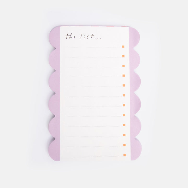 list pad with scalloped edge and 'the list' text on a white background
