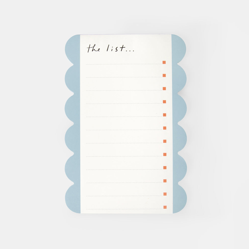 A rectangular lined list pad with scalloped light blue edges and the handwritten text 'the list.