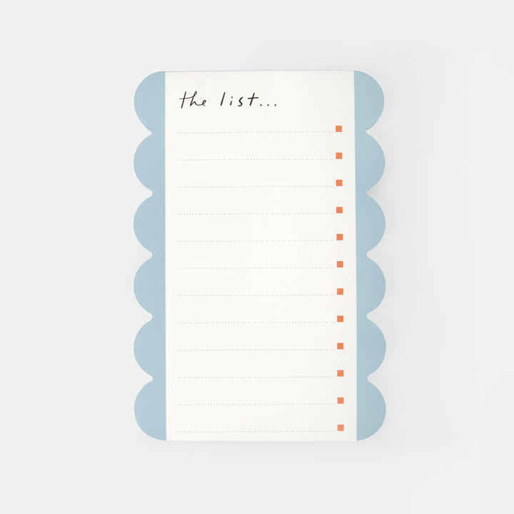 A rectangular lined list pad with scalloped light blue edges and the handwritten text 'the list.