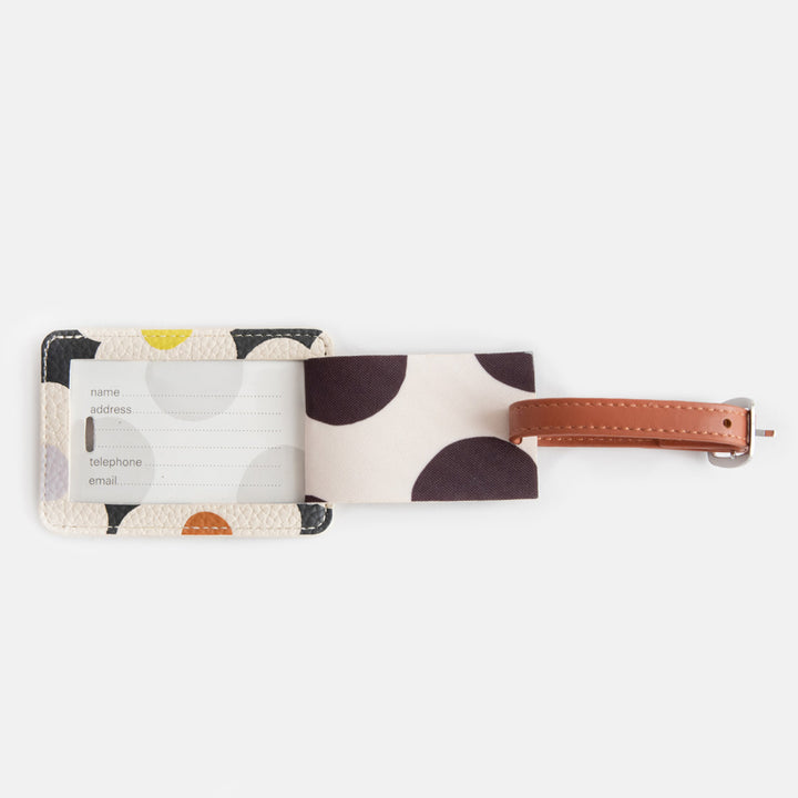 leather look PU luggage tag in multi flower charcoal print with tan buckled strap and mono spot lining