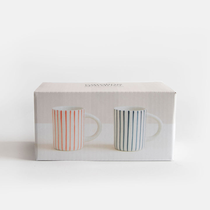 Two striped espresso coffee cups in a box on a white background