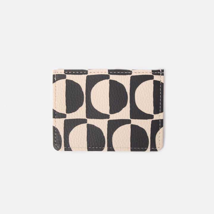 leather look card holder wallet with a monochrome geometric circles design on a white background
