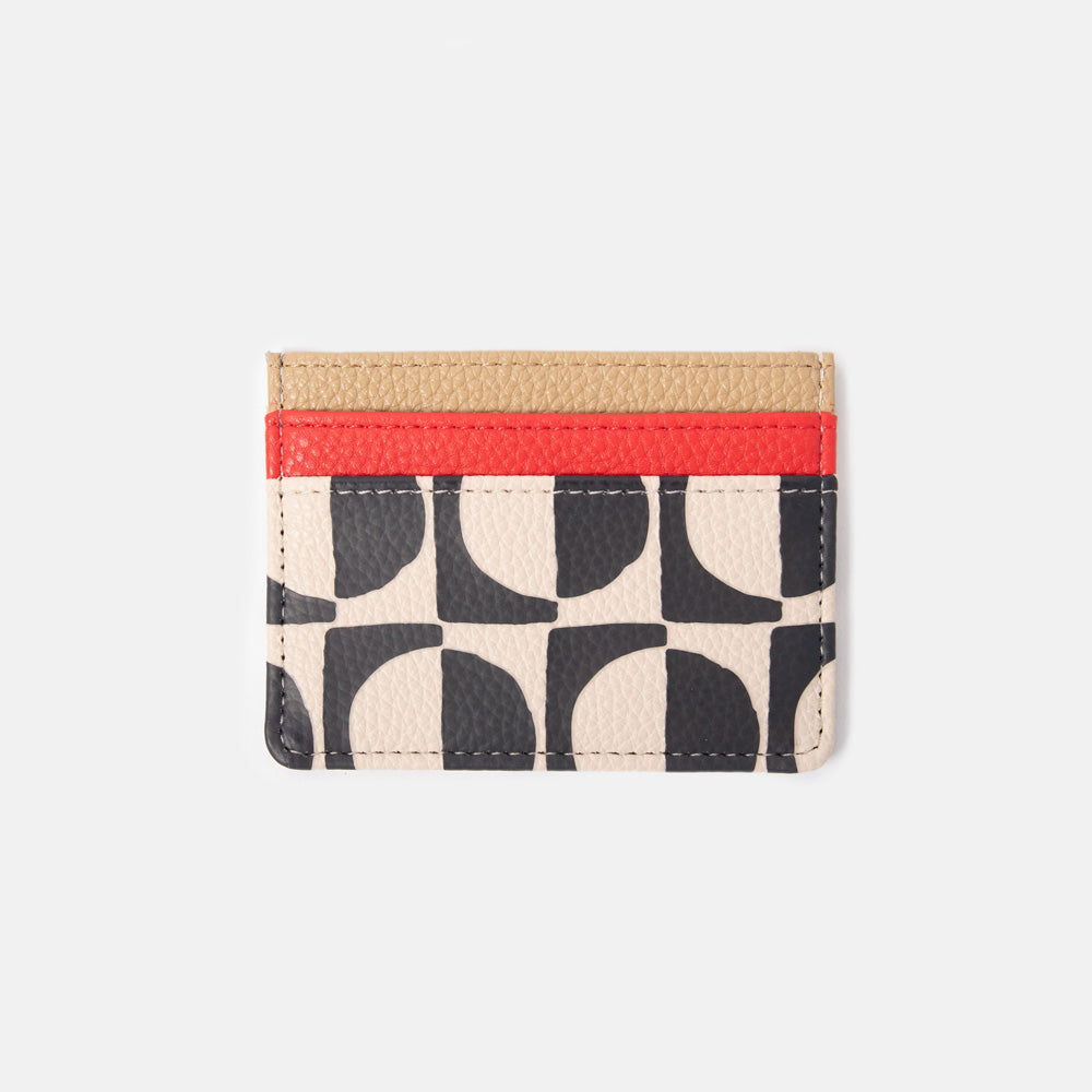 leather look card holder wallet with a monochrome geometric circles design and red & sand colour contrast trim card slots