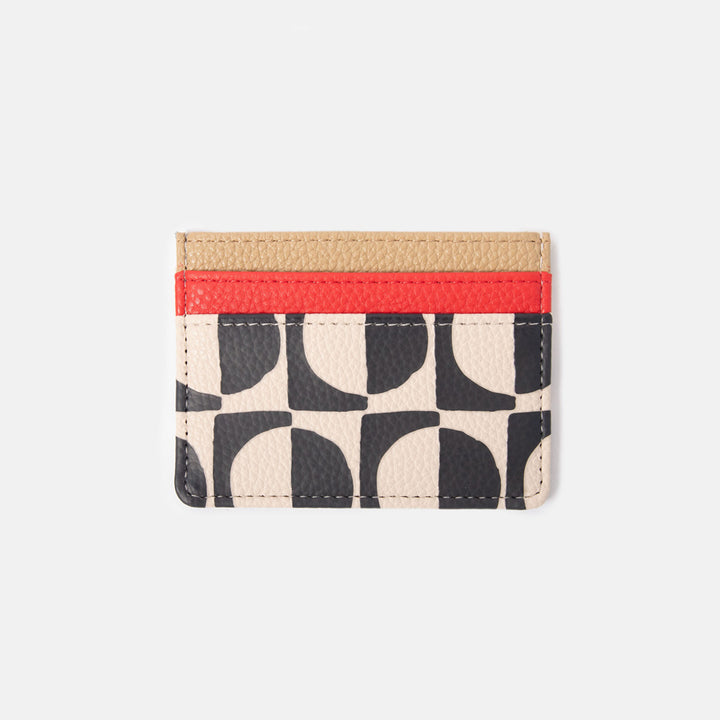 leather look card holder wallet with a monochrome geometric circles design and red & sand colour contrast trim card slots