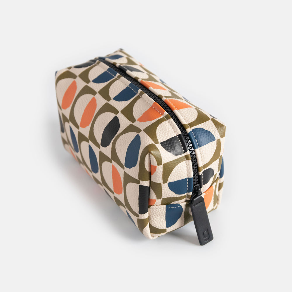 vegan leather look wash bag in green, blue, white & orange retro geometric circles print