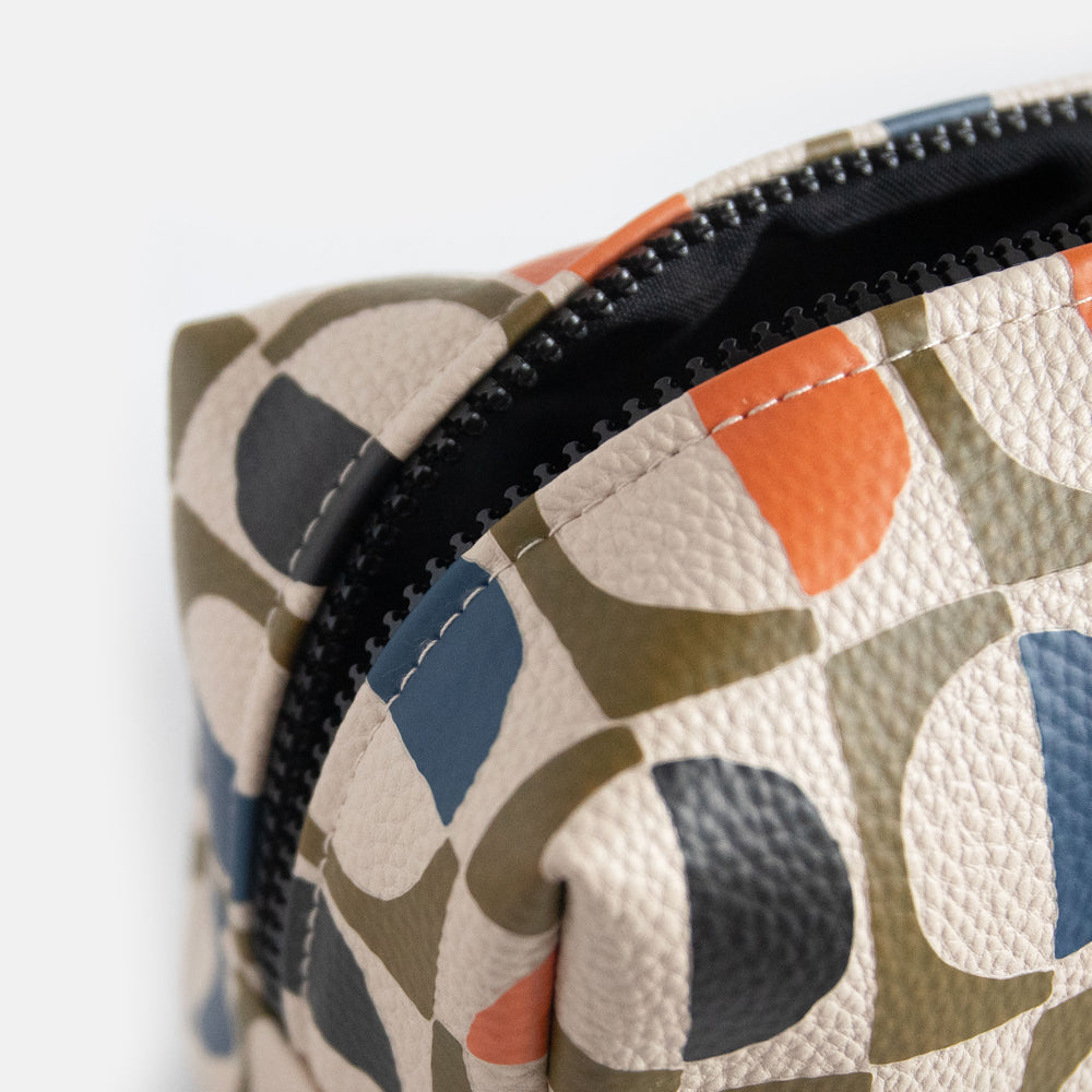 vegan leather look wash bag in green, blue, white & orange retro geometric circles print