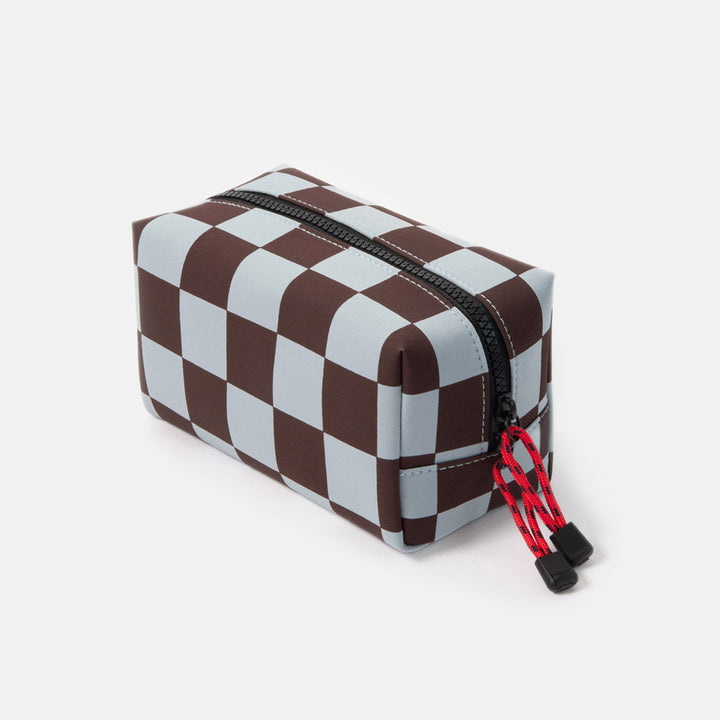 dark purple and light blue checked grooming back with black zip and red zip pulls on a white background