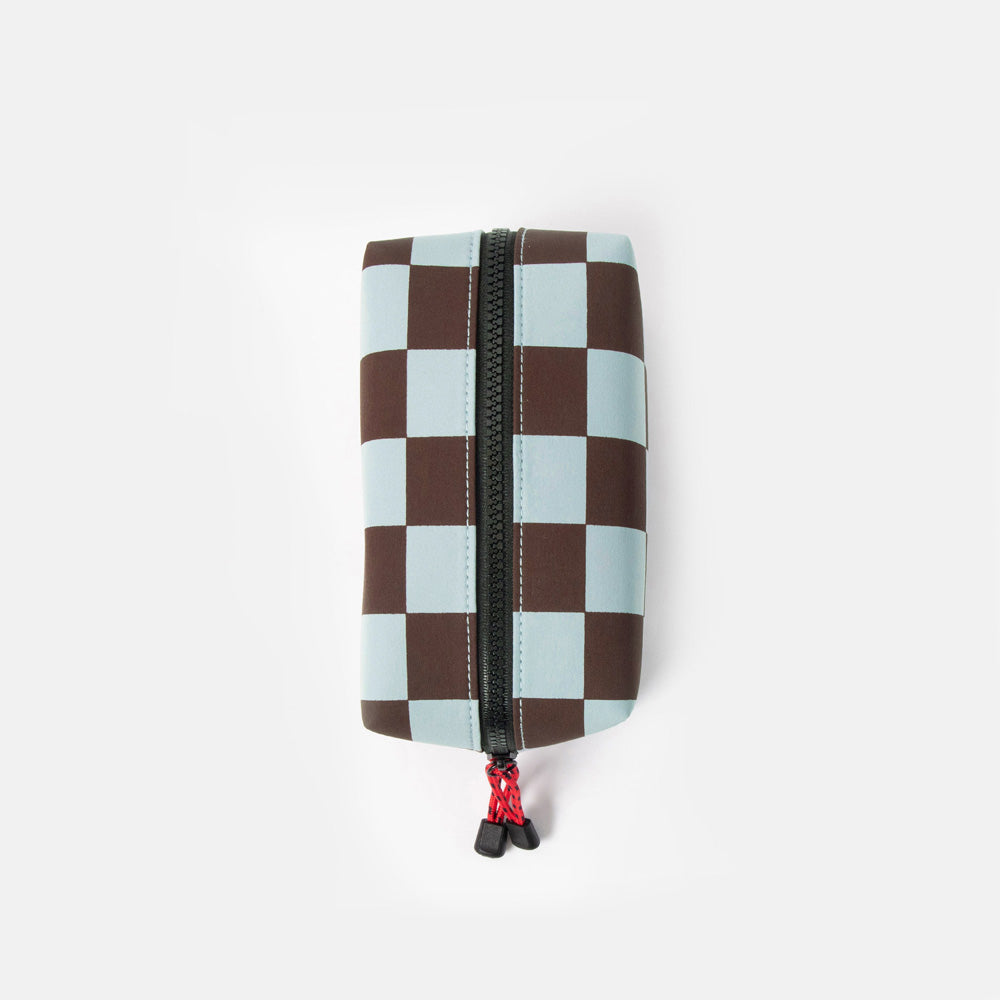 dark purple and light blue checked grooming back with black zip and red zip pulls on a white background