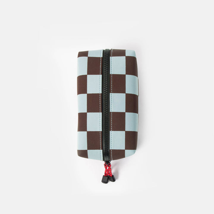 dark purple and light blue checked grooming back with black zip and red zip pulls on a white background