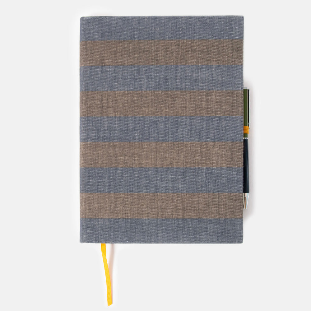 khaki and navy blue striped notebook & pen set on a white background
