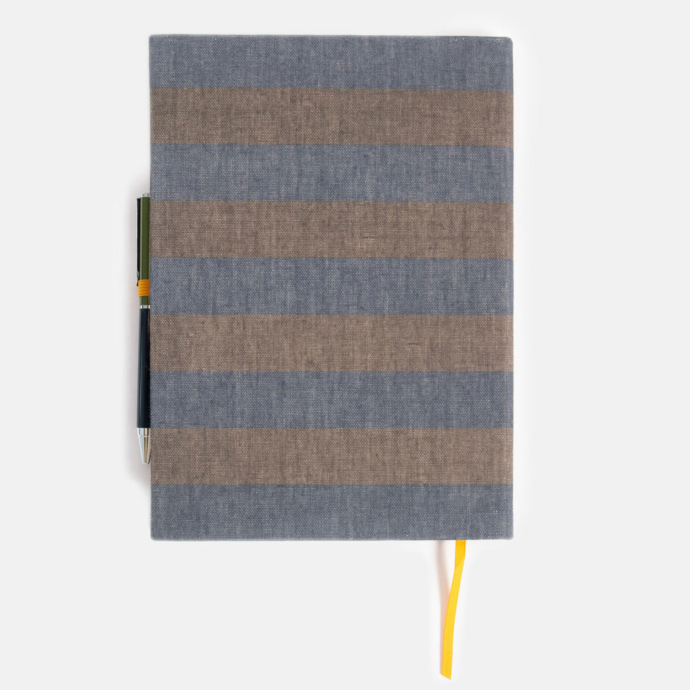 khaki and navy blue striped notebook & pen set on a white background