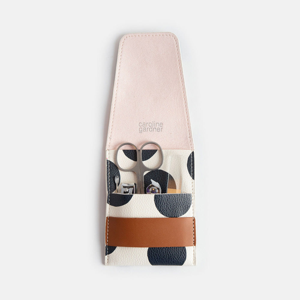 manicure set with nail file, scissors, nail clippers, cuticle clippers & cuticle tool in a spot print leather look PU holder