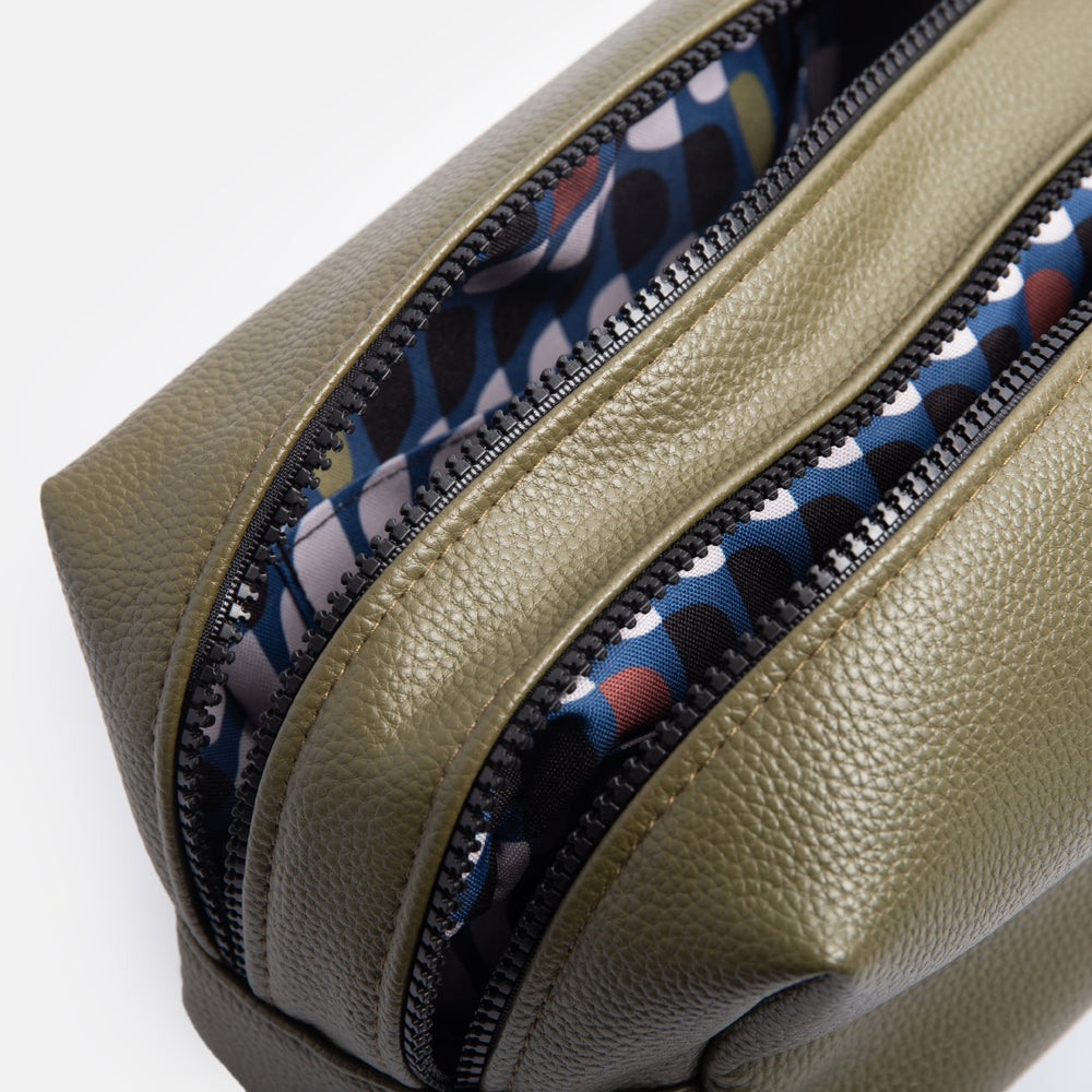 green leather look large travel washbag with double zip opening and retro geometric print wipe clean lining