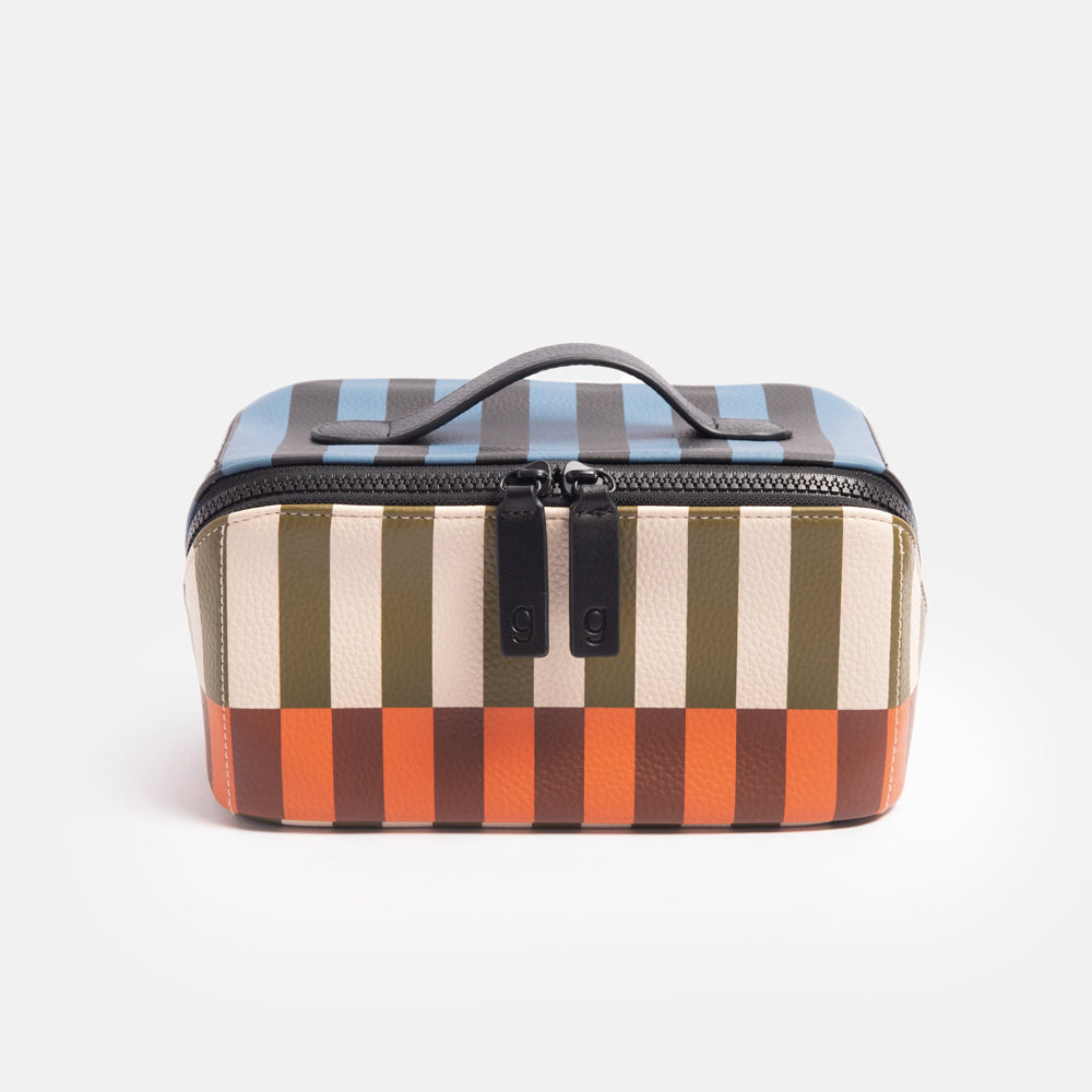 diagonal zip flat lay vegan leather wash bag in retro stripe print in orange, brown, green, white and blue
