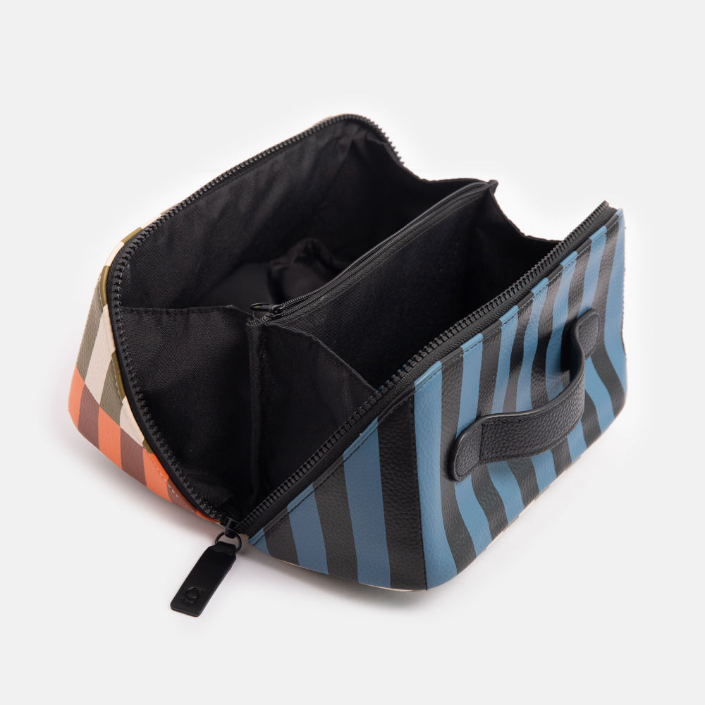 diagonal zip flat lay vegan leather wash bag in retro stripe print in orange, brown, green, white and blue with wipe clean lining
