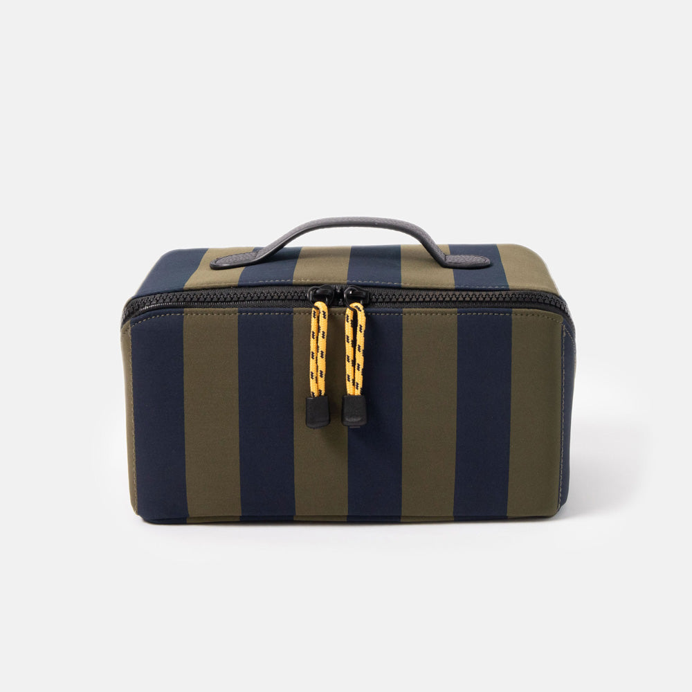 blue and green striped wash bag with black zip, yellow zip pulls and black top grab handle on a white background