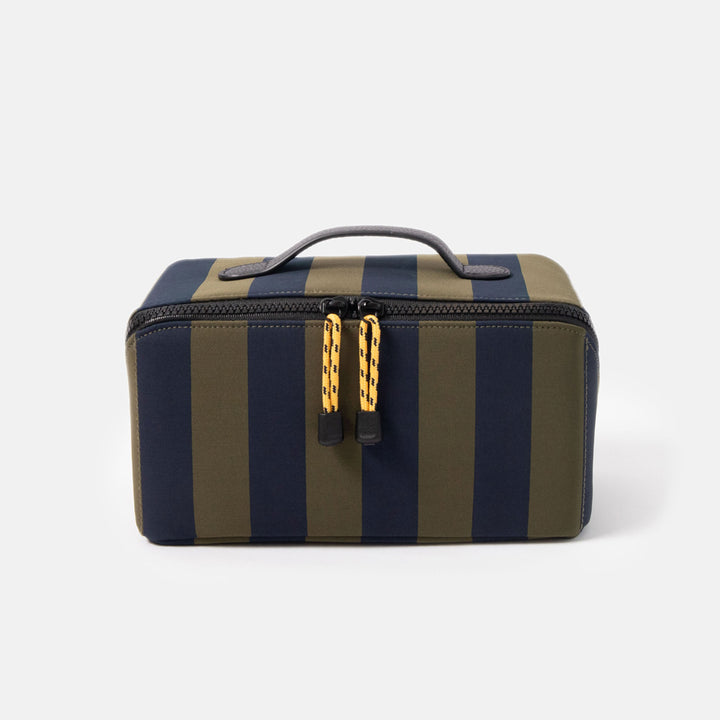 blue and green striped wash bag with black zip, yellow zip pulls and black top grab handle on a white background