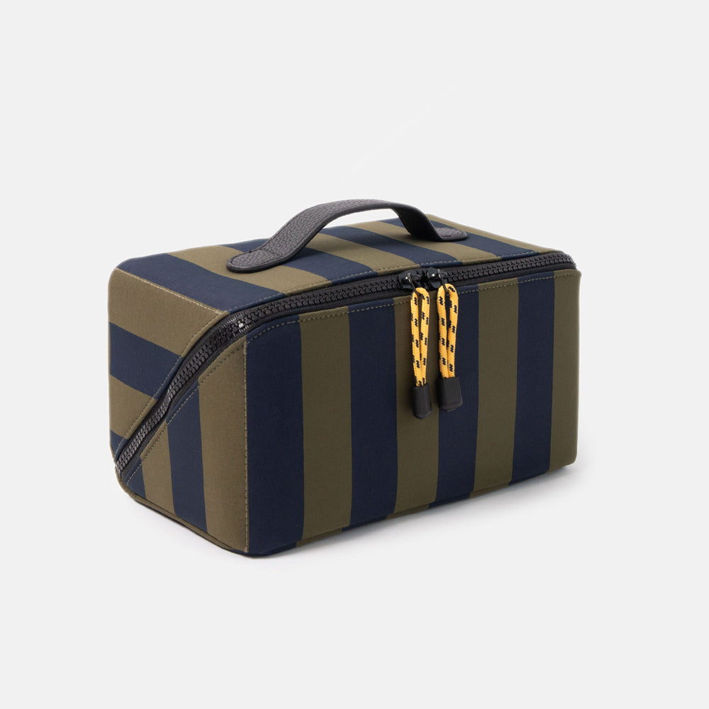 blue and green striped wash bag with black zip, yellow zip pulls and black top grab handle on a white background