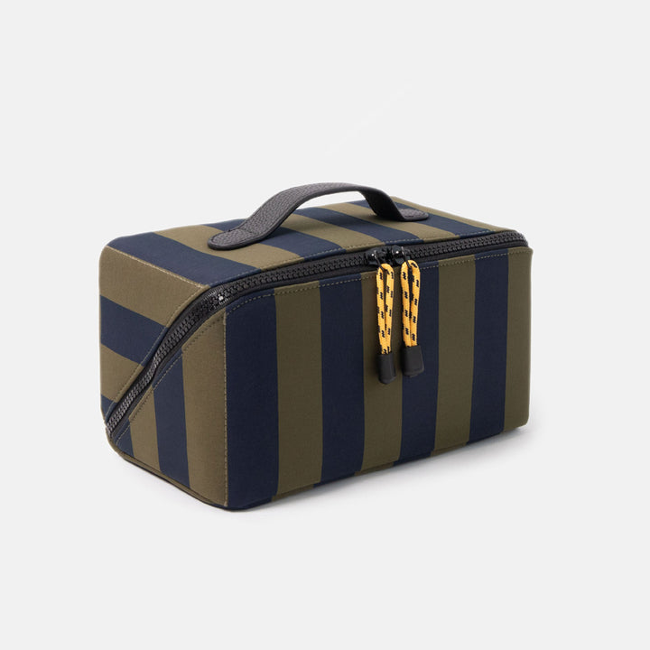 blue and green striped wash bag with black zip, yellow zip pulls and black top grab handle on a white background