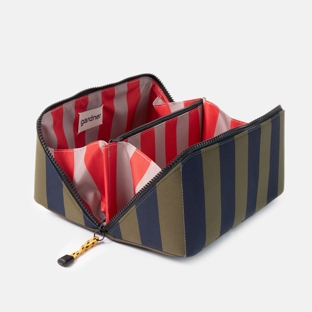 blue and green striped flat lay wash bag with diagonal zip, open showing red and sand stripe internal lining and 'gardner' branded tab