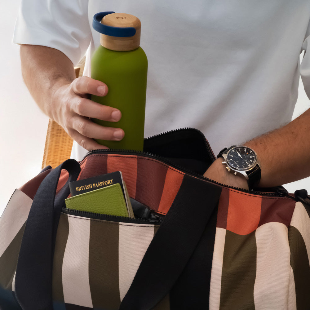 nylon barrel gym bag in retro style stripe design in orange, brown, green, white, blue & black