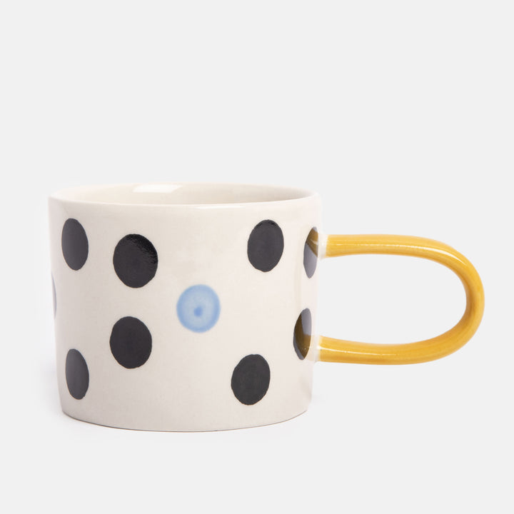 hand painted ceramic stoneware mug with black and blue dots design and mustard yellow elongated handle