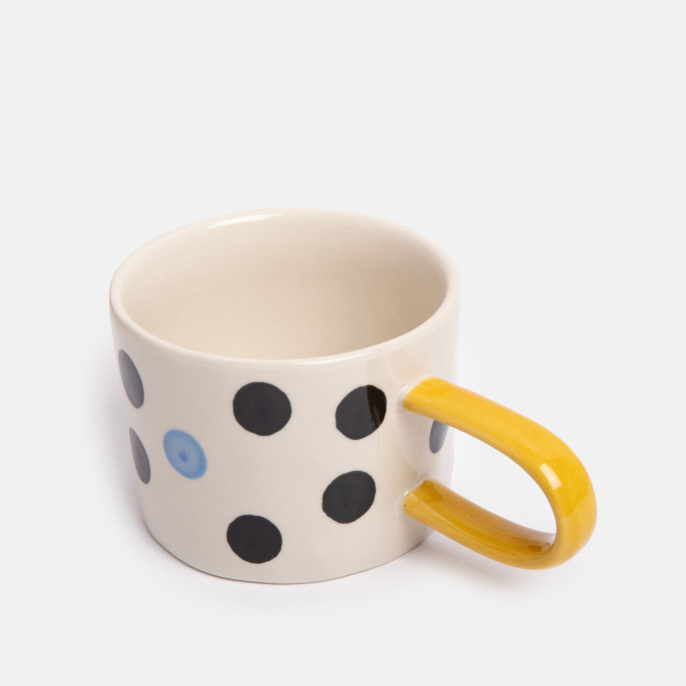 hand painted ceramic stoneware mug with black and blue dots design and mustard yellow elongated handle