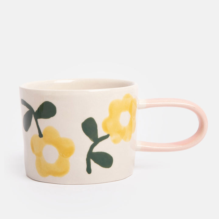 hand painted ceramic stoneware mug with yellow flowers design and pale pink elongated handle