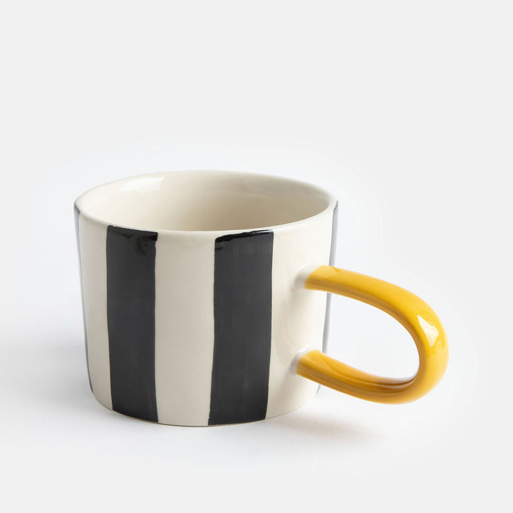 hand painted ceramic stoneware mug with black stripes design and a mustard elongated handle