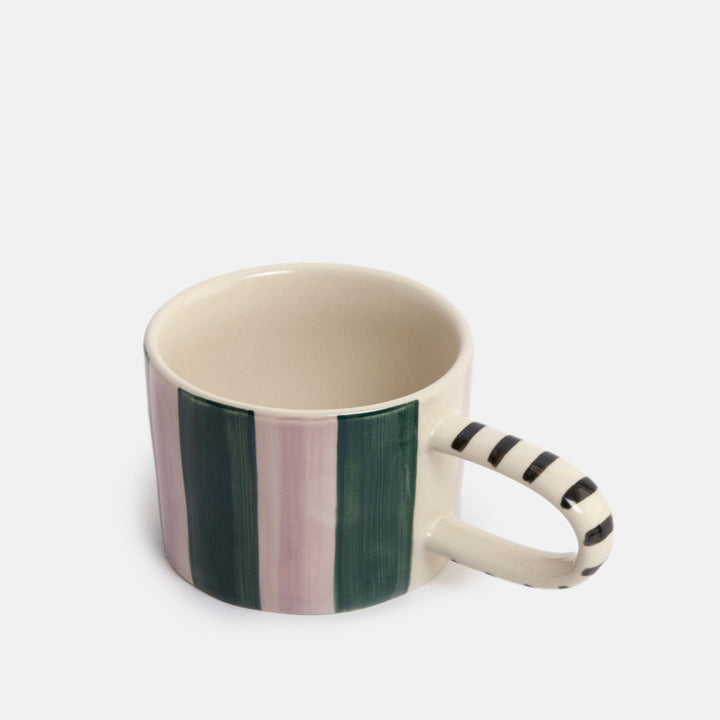 A ceramic mug with a cream-colored interior and exterior, featuring vertical stripes in dark green and dusty pink on the body, and a striped handle.