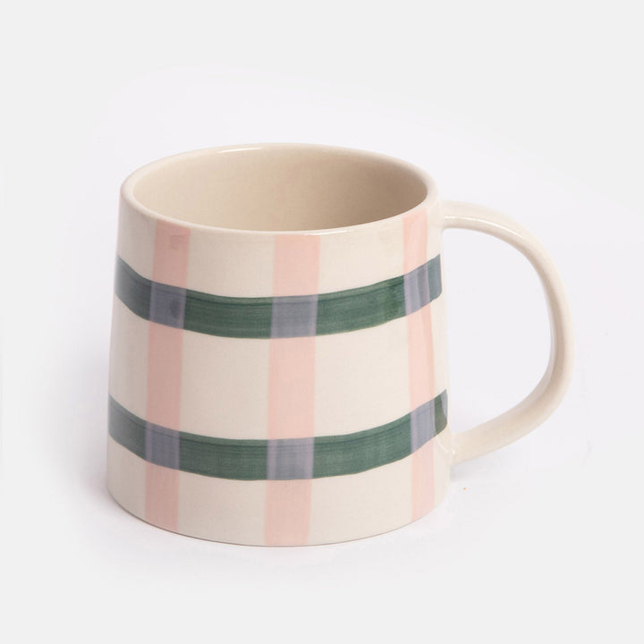 mug with a pink and green check design on a light grey background