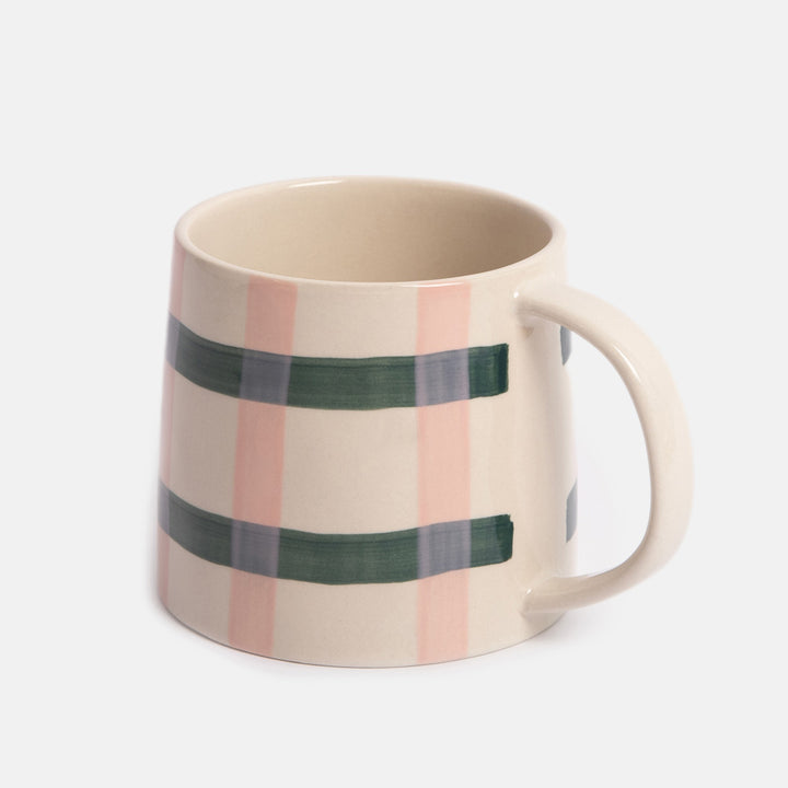 mug with a pink and green check design on a light grey background