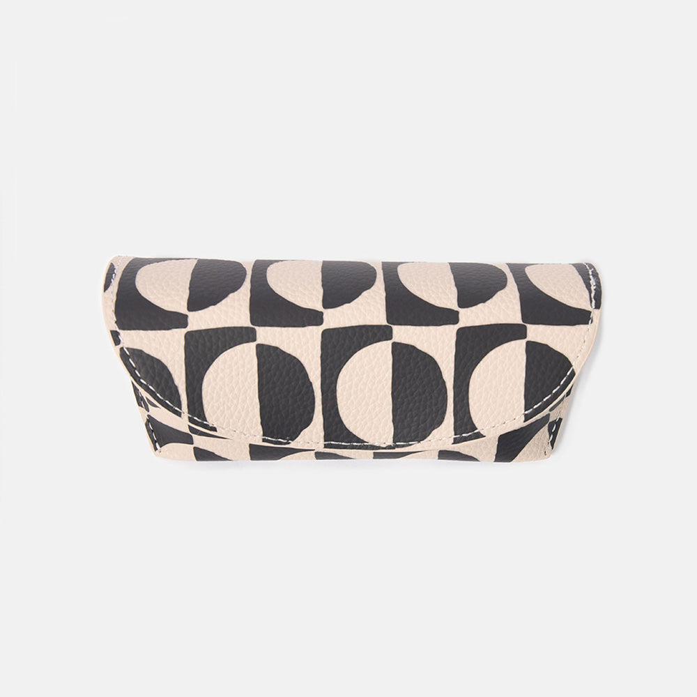 black and white geometric circles design leather look glasses case on a white background