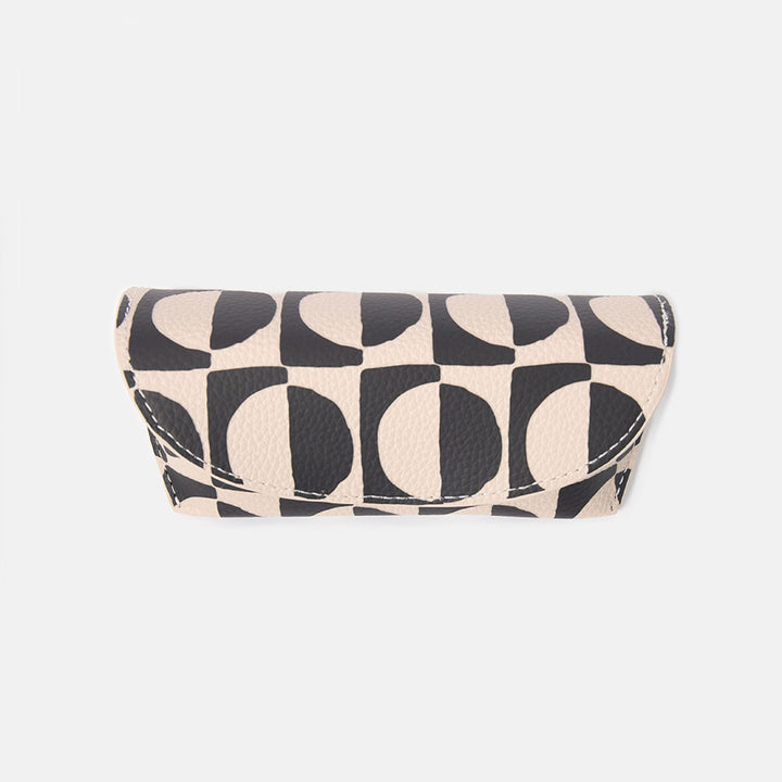 black and white geometric circles design leather look glasses case on a white background