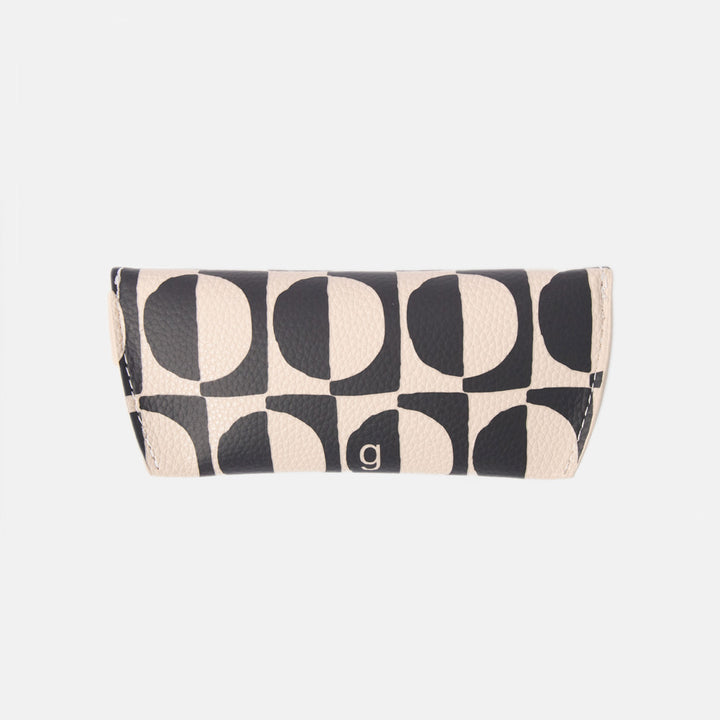 black and white geometric circles design leather look glasses case on a white background