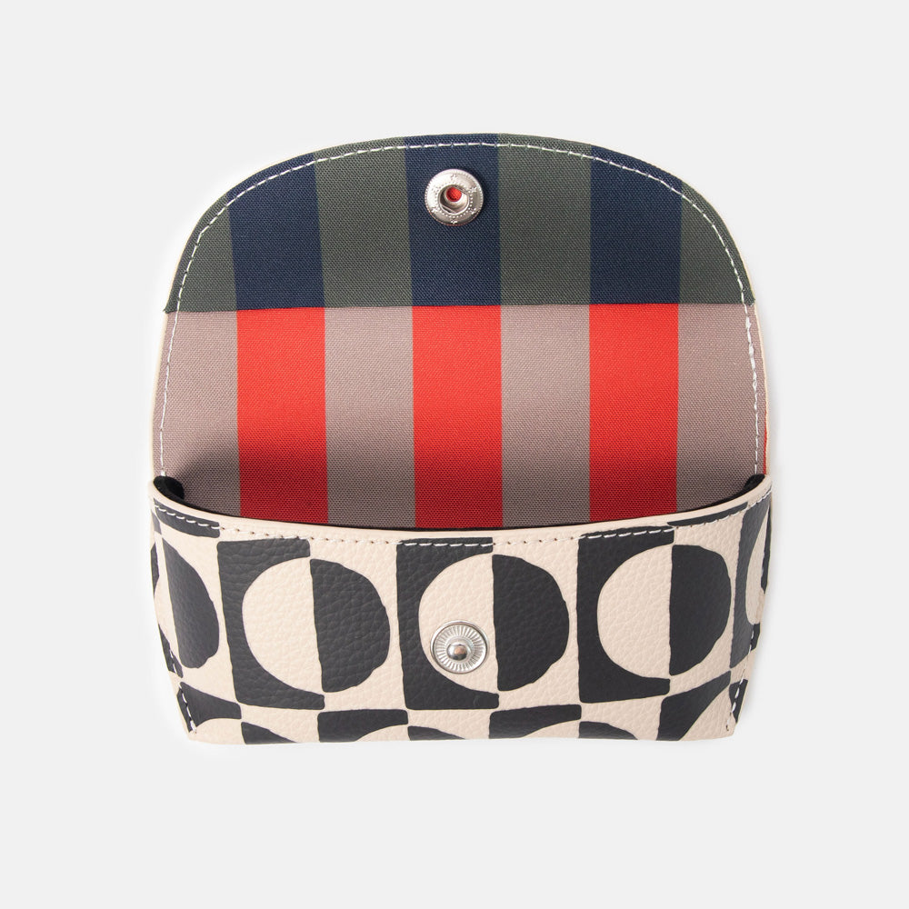 black and white geometric circles design leather look glasses case with a colourful striped internal lining