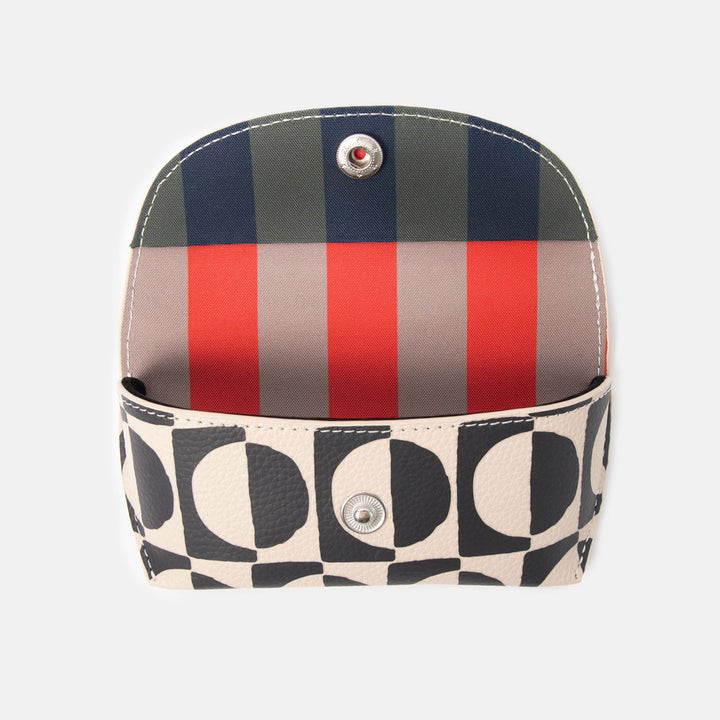 black and white geometric circles design leather look glasses case with a colourful striped internal lining