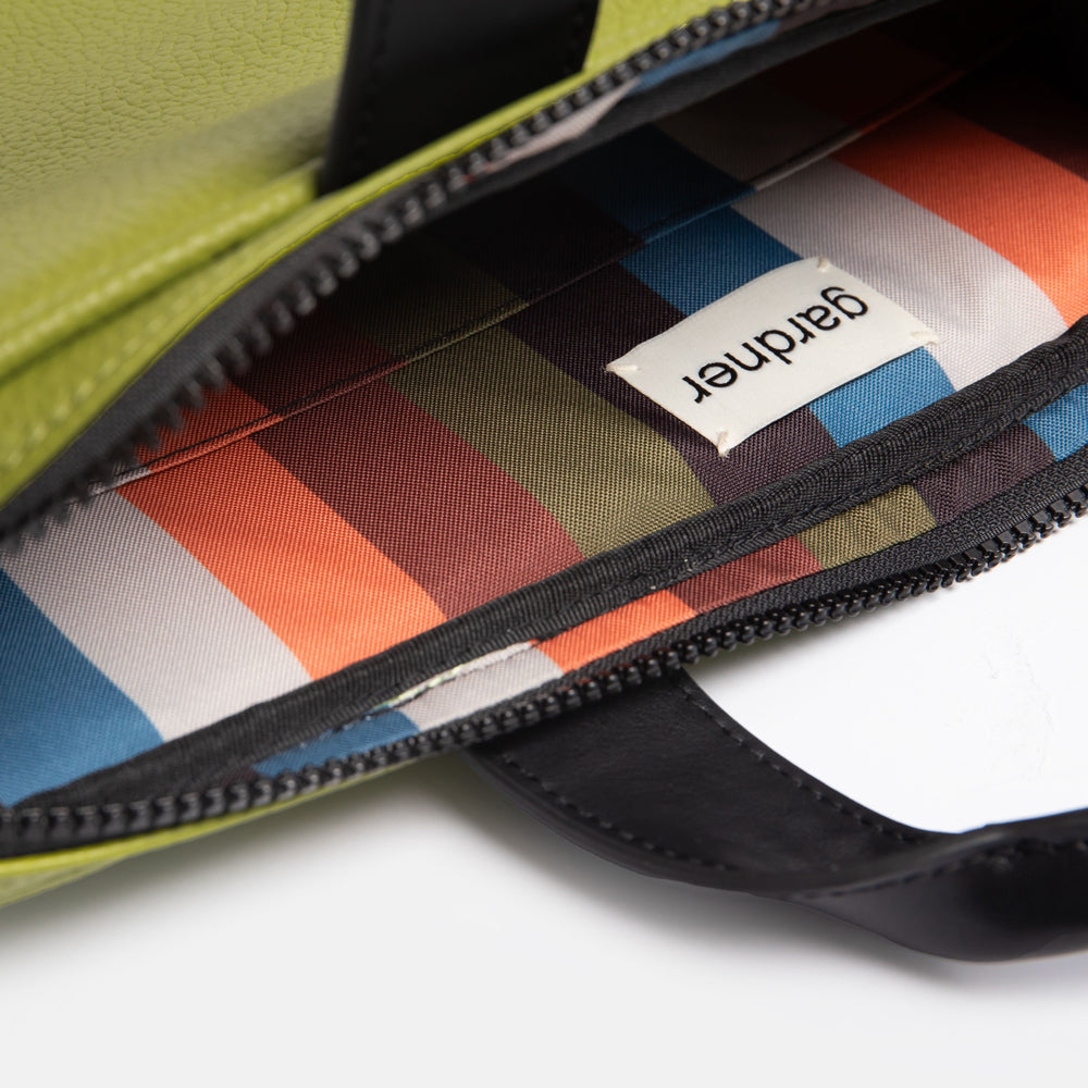 moss green vegan leather laptop bag with retro stripe lining in orange, green, brown, blue & black