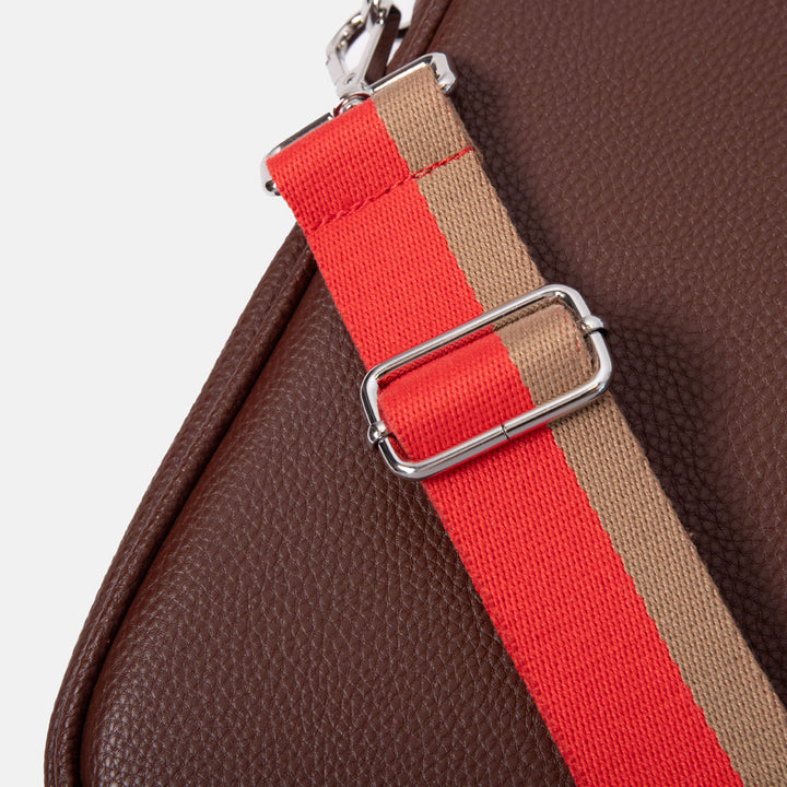 close up of dark purple leather look laptop bag with red & sand stripe webbing shoulder strap