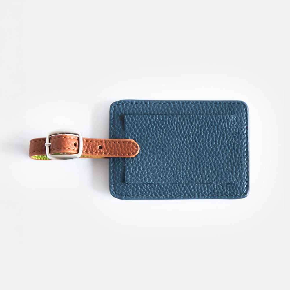 vegan leather navy luggage tag with brown strap and silver buckle