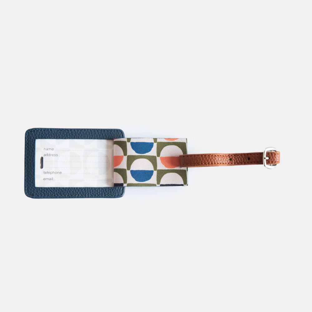 vegan leather navy luggage tag with brown strap and information window flap