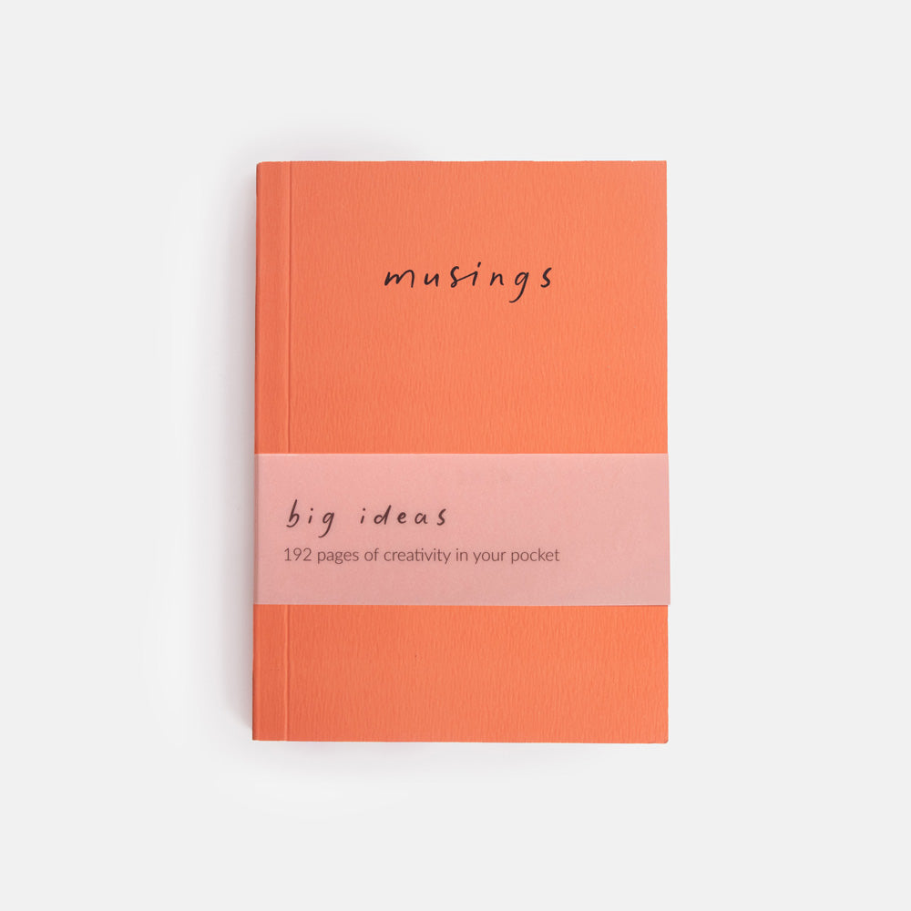 Notebook with 'musings big ideas' text on a white background