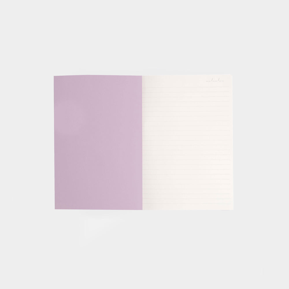 inside cover of a notebook with a lilac page and a white lined page