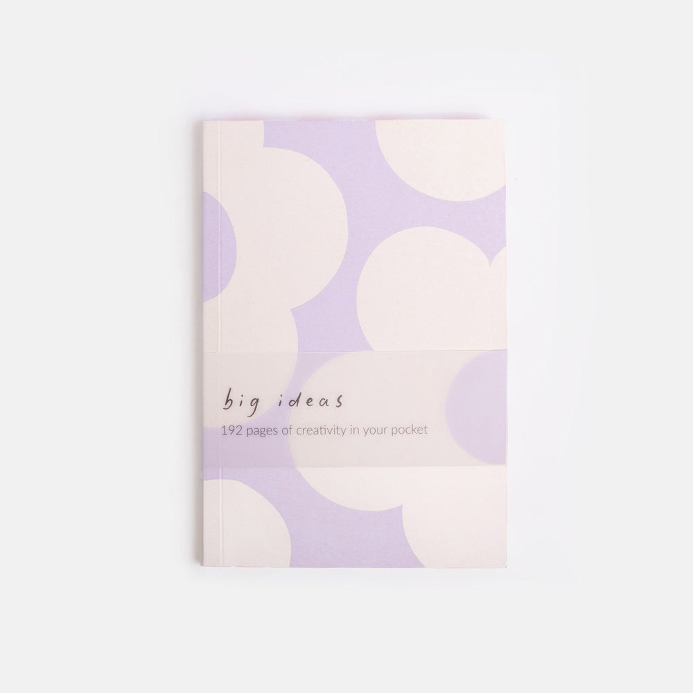 Notebook with white flower design on a light purple background