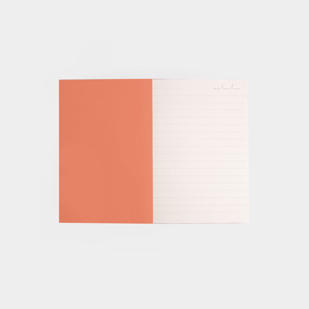notebook internal with orange inside cover and white lined paged